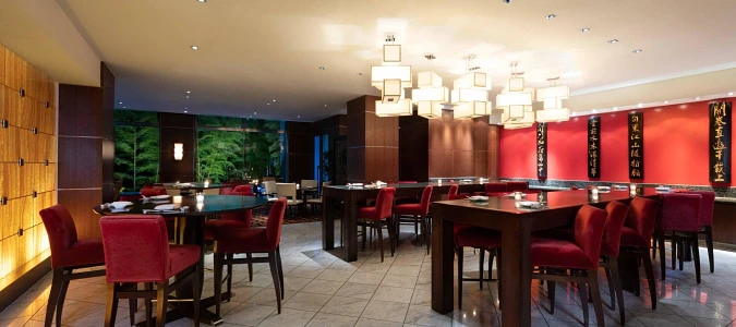 A restaurant with tables and chairsAI-generated content may be incorrect.
