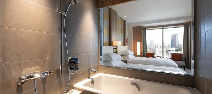 A bathroom with a bathtub and a mirrorAI-generated content may be incorrect.