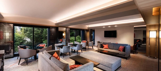 A room with couches and tablesAI-generated content may be incorrect.
