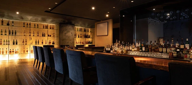 A bar with a bar and chairsAI-generated content may be incorrect.